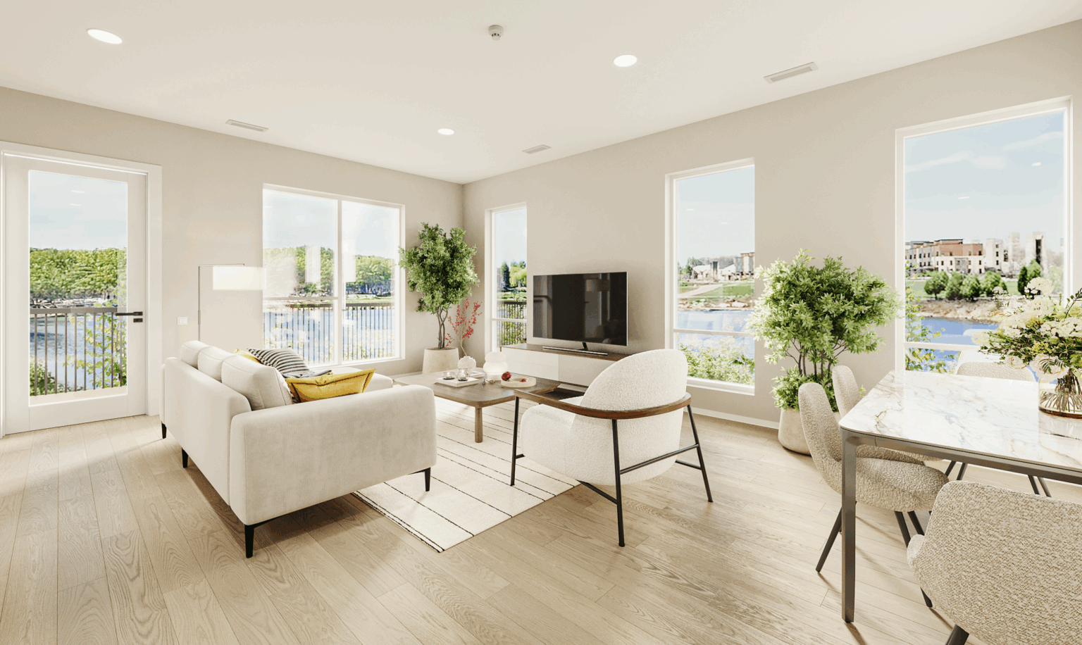 Bright modern living room at South Bank at Quarry Trails with large windows, neutral furniture, wooden flooring, indoor plants, a TV, and a view of the river and city buildings.